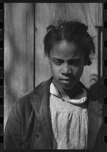 Untitled photo, possibly related to: Oldest daughter of Pomp Hall, tenant farmer, with an ear of corn which she is shelling to feed her chickens, Creek County, Oklahoma. See general caption number 23