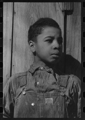 Untitled photo, possibly related to: Son of Pomp Hall, Negro tenant farmer, eating black walnuts which were grown on their farm in Creek County, Oklahoma. See general caption number 23