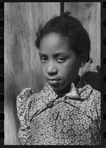 Untitled photo, possibly related to: Daughter of Pomp Hall, Negro tenant farmer, feeding corn to her three chickens which were her 4-H Club project, Creek County, Oklahoma. See general caption number 23