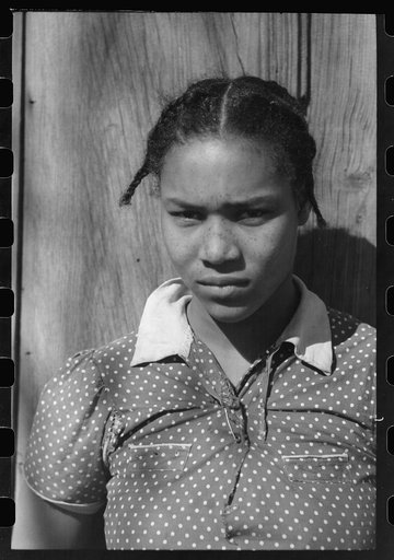 Untitled photo, possibly related to: Oldest daughter of Pomp Hall, tenant farmer, with an ear of corn which she is shelling to feed her chickens, Creek County, Oklahoma. See general caption number 23
