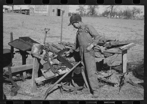Untitled photo, possibly related to: Son of Pomp Hall, Negro tenant farmer, eating black walnuts which were grown on their farm in Creek County, Oklahoma. See general caption number 23