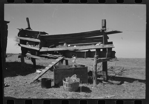 Untitled photo, possibly related to: Son of Pomp Hall, Negro tenant farmer, carrying can full of mash to hogpen, Creek County, Oklahoma. See general caption, number 23