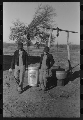 Untitled photo, possibly related to: Son of Pomp Hall, Negro tenant farmer, carrying can full of mash to hogpen, Creek County, Oklahoma. See general caption, number 23