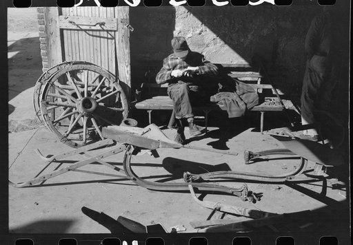 Untitled photo, possibly related to: Blacksmith's helper disassembling plow belonging to Pomp Hall, Negro tenant farmer from Creek County, Oklahoma. Blacksmith shop is in Depew, Oklahoma. See general caption number 23
