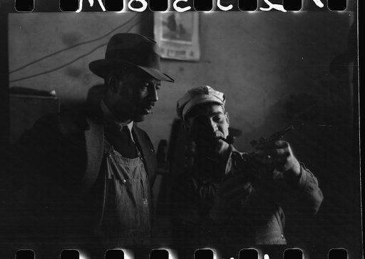 Untitled photo, possibly related to: Pomp Hall, Negro tenant farmer, talking to another farmer as he waits at the blacksmith shop in Depew, Oklahoma for his plow points to be sharpened. Pomp Hall is considered one of the best farmers in this county and is consulted by Negroes and whites concerning f