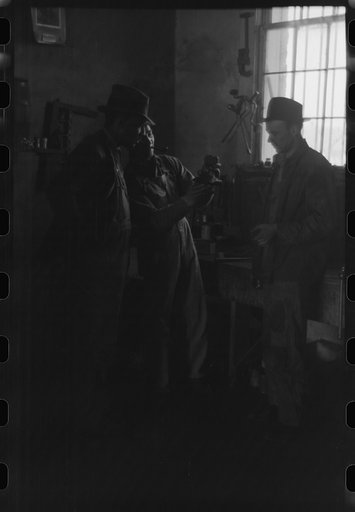 Untitled photo, possibly related to: Pomp Hall, Negro tenant farmer, talking to another farmer as he waits at the blacksmith shop in Depew, Oklahoma for his plow points to be sharpened. Pomp Hall is considered one of the best farmers in this county and is consulted by Negroes and whites concerning f