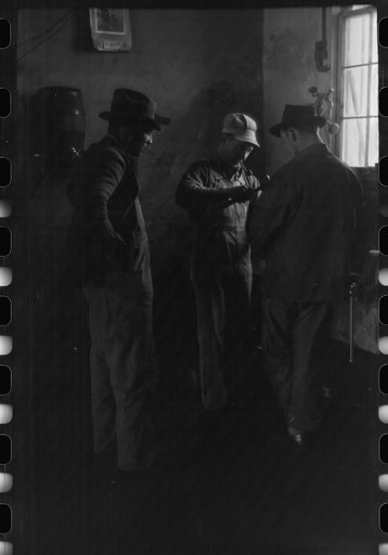 Untitled photo, possibly related to: Pomp Hall, Negro tenant farmer, talking to another farmer as he waits at the blacksmith shop in Depew, Oklahoma for his plow points to be sharpened. Pomp Hall is considered one of the best farmers in this county and is consulted by Negroes and whites concerning f
