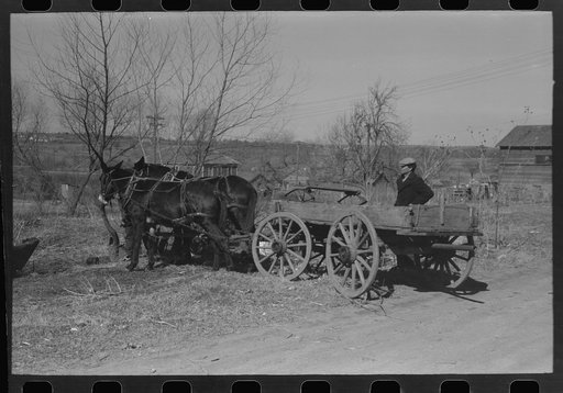 Untitled photo, possibly related to: Pomp Hall, Negro tenant farmer, talking to another farmer as he waits at the blacksmith shop in Depew, Oklahoma for his plow points to be sharpened. Pomp Hall is considered one of the best farmers in this county and is consulted by Negroes and whites concerning f