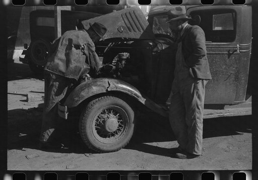 Untitled photo, possibly related to: Pomp Hall, Negro tenant farmer, talking to another farmer as he waits at the blacksmith shop in Depew, Oklahoma for his plow points to be sharpened. Pomp Hall is considered one of the best farmers in this county and is consulted by Negroes and whites concerning f