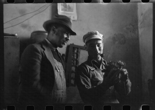Untitled photo, possibly related to: Pomp Hall, Negro tenant farmer, talking to another farmer as he waits at the blacksmith shop in Depew, Oklahoma for his plow points to be sharpened. Pomp Hall is considered one of the best farmers in this county and is consulted by Negroes and whites concerning f