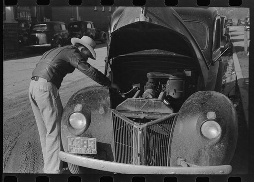 Farmer working on his car while he is in town, Eufaula, Oklahoma