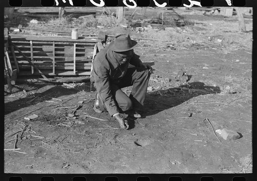 Untitled photo, possibly related to: Negro playing marbles on the first warm day in the spring. In this game the players shoot from hole to hole, the same idea as in golf or miniature golf. Eufaula, Oklahoma