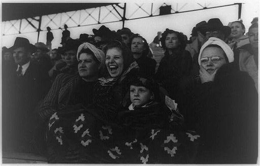 Spectators at a tense moment during the rodeo at the San Angelo Fat Stock Show, San Angelo, Texas