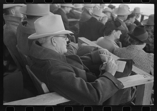 Untitled photo, possibly related to: Spectator checking time of the calf ropers at the rodeo at the San Angelo Fat Stock Show, San Angelo, Texas