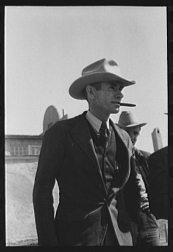Untitled photo, possibly related to: Men watching the judging of Hereford steers at the San Angelo Fat Stock Show, San Angelo, Texas
