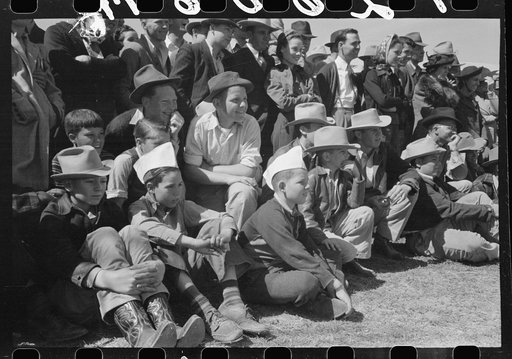 Spectators at a side show where a man unloosens himself from chains and ropes, San Angelo Fat Stock Show, Texas