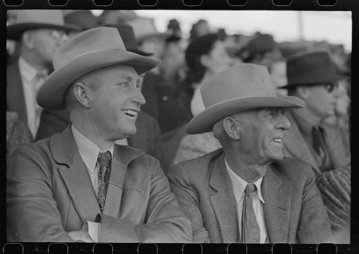 Spectator laughing at the antics of a cowboy clown at the rodeo of the San Angelo Fat Stock Show, San Angelo, Texas