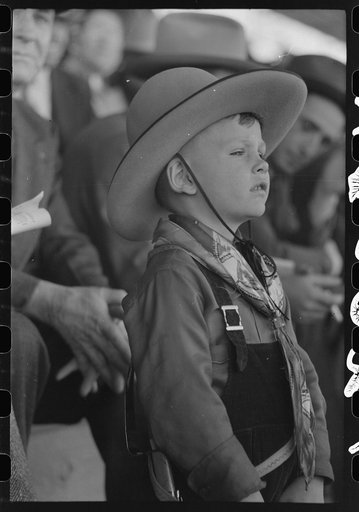 Youngster in cowboy costume watching the rodeo at the San Angelo Fat Stock Show, San Angelo, Texas