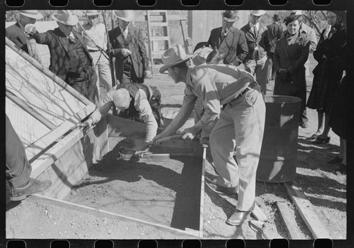 FSA (Farm Security Administration) Supervisor and a rehabilitation borrower preparing and leveling off the seed bed of a frame garden in a demonstration meeting at San Angelo, Texas