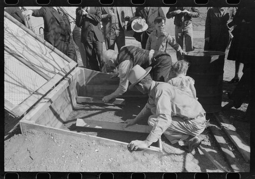 Untitled photo, possibly related to: FSA (Farm Security Administration) Supervisor and a rehabilitation borrower preparing and leveling off the seed bed of a frame garden in a demonstration meeting at San Angelo, Texas