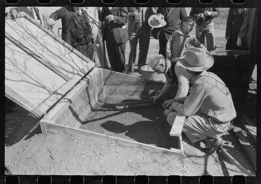 Untitled photo, possibly related to: FSA (Farm Security Administration) Supervisor and a rehabilitation borrower preparing and leveling off the seed bed of a frame garden in a demonstration meeting at San Angelo, Texas