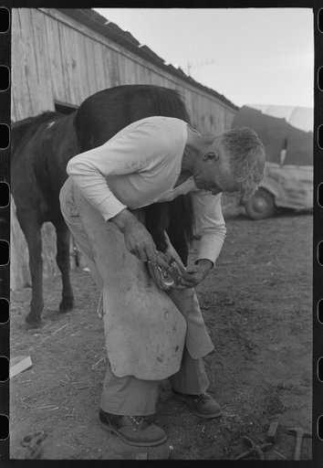 Blacksmith who follows the rodeo performers throughout the country, San Angelo Fat Stock Show, San Angelo, Texas