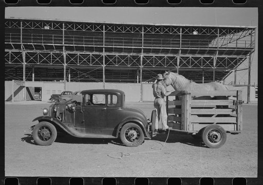 Rodeo performer arriving at the San Angelo Fat Stock Show barn with his horse in trailer, San Angelo, Texas