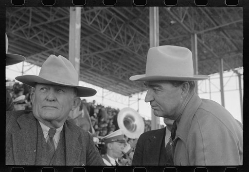 Untitled photo, possibly related to: Group of spectators at sideshow watching man unloosen himself from chains.  San Angelo Fat Stock Show, San Angelo, Texas