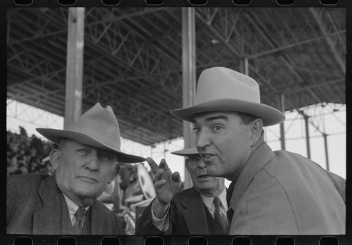 Untitled photo, possibly related to: Group of spectators at sideshow watching man unloosen himself from chains.  San Angelo Fat Stock Show, San Angelo, Texas