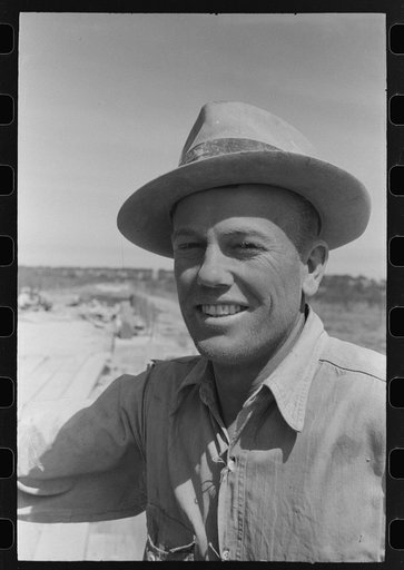 Road worker covered with cement dust, Menard County, Texas