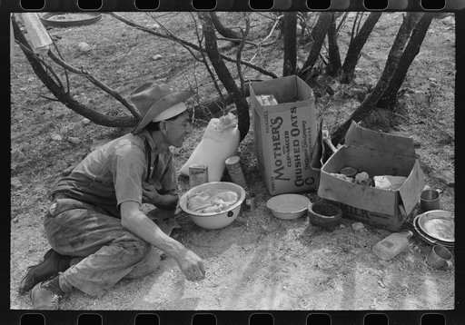 Professional migratory sheep and goat shearer resting after noonday meal on ranch of rehabilitation borrower in Kimble County, Texas