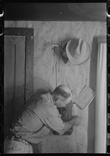 West Texas ranchman making a telephone call, Kimble County, Texas