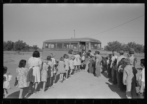 Children of migratory laborers who are living at migratory labor camp at Agua Fria, Arizona, boarding school bus