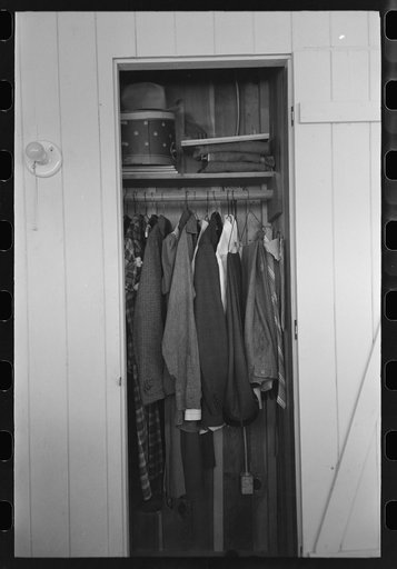 Closet space in apartment of family living and working at the Arizona Part-Time Farms, Chandler Unit, Maricopa County, Arizona