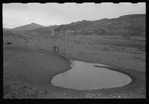Stock waterhole and windmill, Socorro County, New Mexico