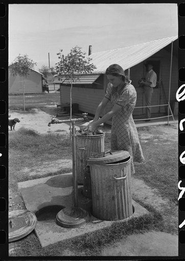 Garbage disposal and water supply at end of the row shelters in Agua Fria Migratory Labor Camp, Arizona