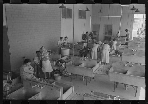 Wives of migratory laborers in the laundry room at the Agua Fria Migratory Labor Camp, Arizona