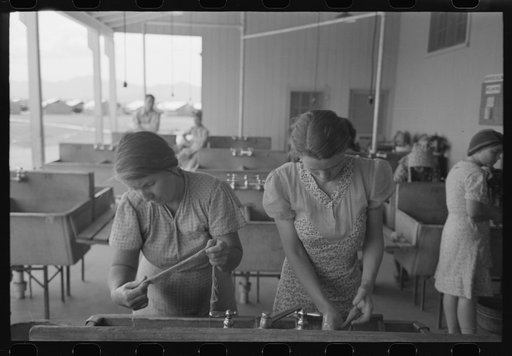 Wives of migratory laborers washing their family laundry at the Agua Fria Migratory Labor Camp, Arizona. The difference in the personal appearance of the migratory workers when hot water and laundry facilities are available is striking and indicates that hard work in the fields and life on the road 