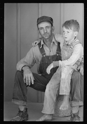 Migratory laborer and his son living at the Agua Fria Migratory Labor Camp, Arizona
