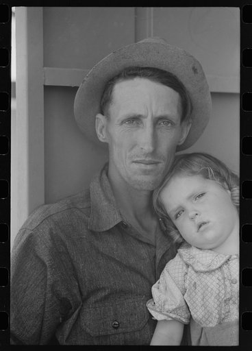 Migrant worker and his child at the Agua Fria Migratory Labor Camp, Arizona