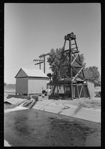 Deep well and pump house at side of irrigation ditch, Maricopa County, Arizona