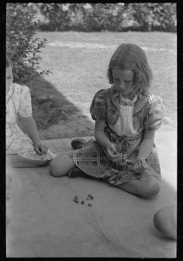 Untitled photo, possibly related to: Little girl playing jacks at the Casa Grande Valley Farms, Pinal County, Arizona