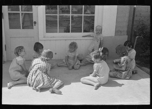 Little girl playing jacks at the Casa Grande Valley Farms, Pinal County, Arizona