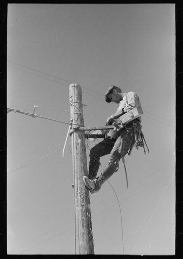 Untitled photo, possibly related to: Lineman on telephone pole at the Casa Grande Valley Farms, Pinal County, Arizona