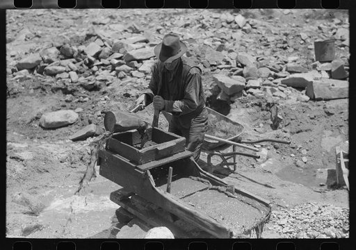 Gold prospector pouring water through his "rocker," Pinos Altos, New Mexico. He was born in Fremont, Nebraska on Eugene Fields's death day and so was named Eugene by a romantically minded mother. Pinos Altos, New Mexico