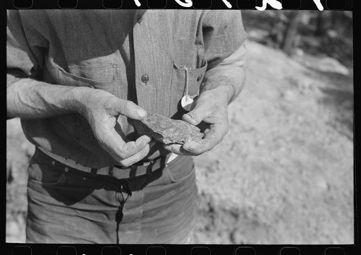 Piece of ore in hand of prospector, Pinos Altos, New Mexico