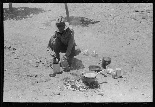 Faro Caudill making coffee for dinner the day he moved his dugout. Pie Town, New Mexico