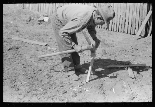 Faro Caudill making posts for his tent in which the family will live while the dugout is being rebuilt near the well. Pie Town, New Mexico