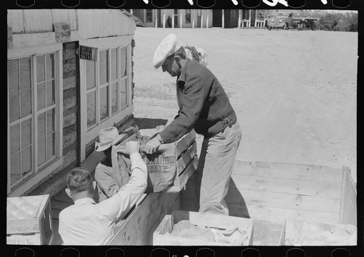 Untitled photo, possibly related to: Mr. Keele taking crate of grapefruit from truck. General store, Pie Town, New Mexico