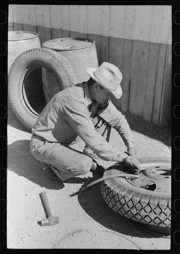 Changing tire at the garage. Pie Town, New Mexico